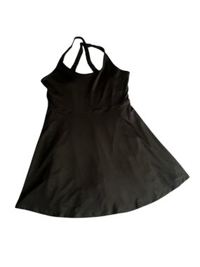 Black athletic dress with built-in shorts with side pockets and a sports bra.